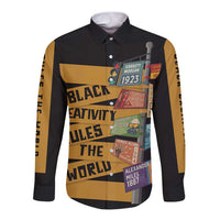 Black long-sleeve button-down shirt with bold African-style poster graphic, front view