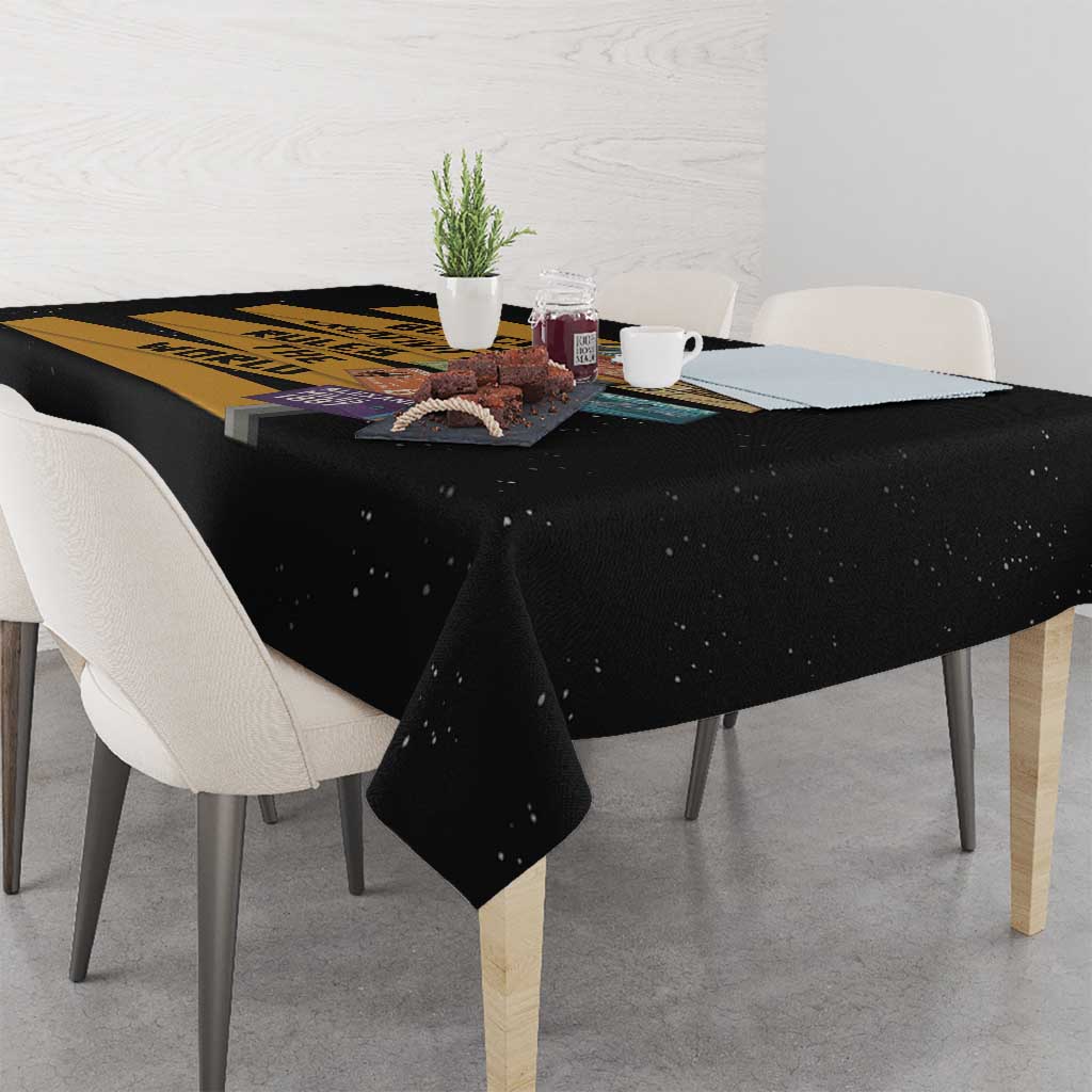 Black tablecloth draped on dining table with colorful creative text