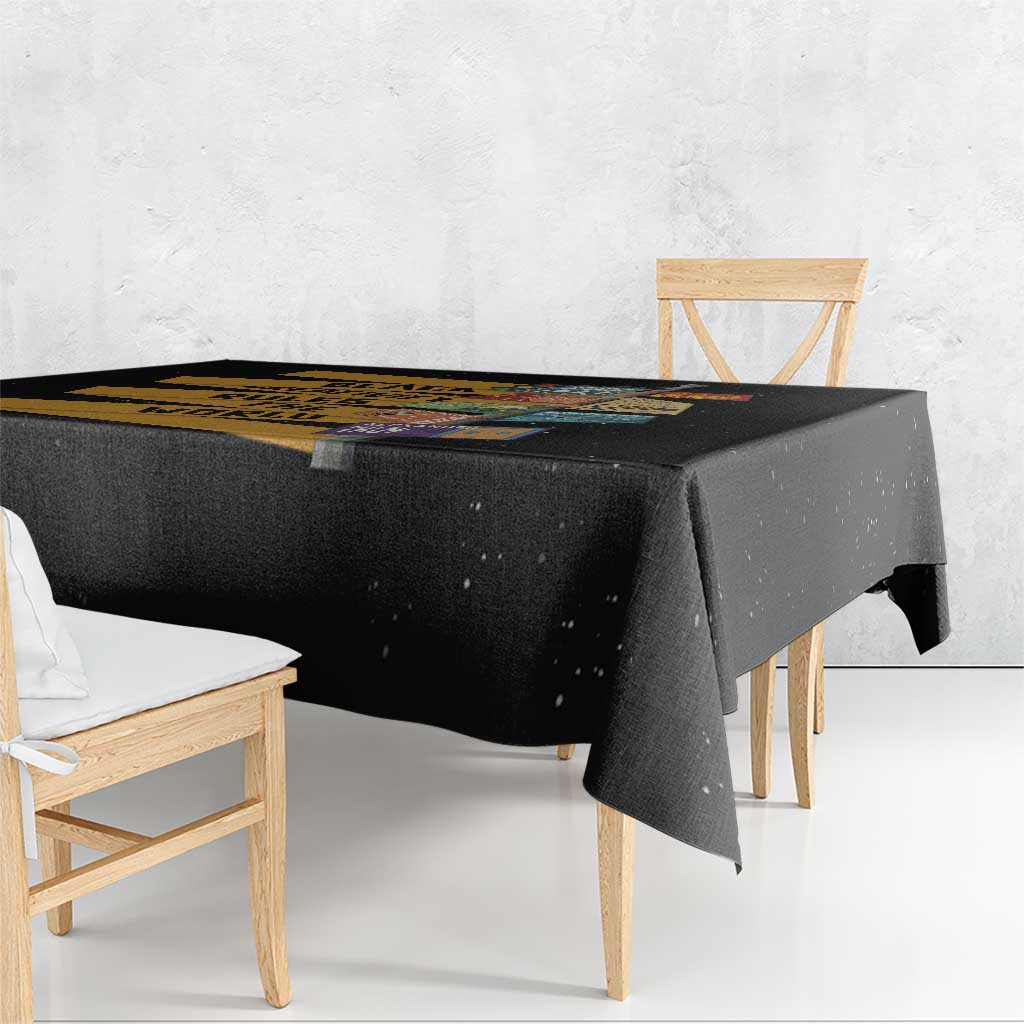 Corner view of black tablecloth with colorful African creativity stripe design