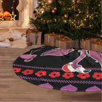 Round black tree skirt with pink flamingos and decorative border, white fringe