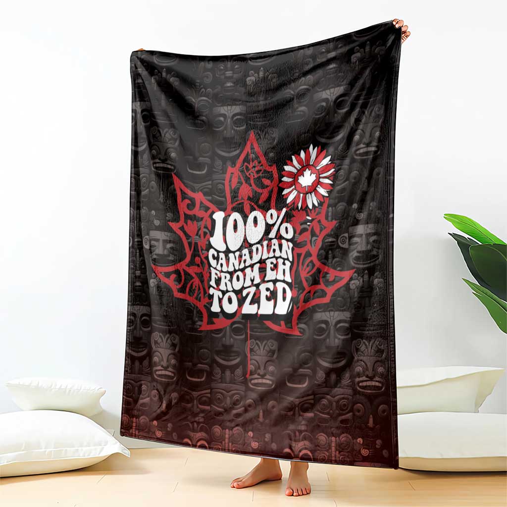 Black throw blanket with red 100% Canada text and white maple-flower emblem