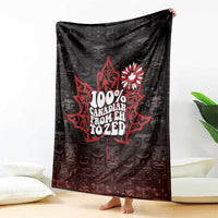 Black throw blanket with red 100% Canada text and white maple-flower emblem