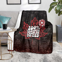 Black throw blanket on gray chair with red Canada 'Eh to Zed' center graphic