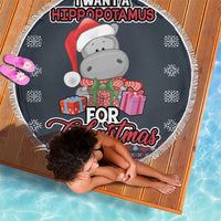 Round dark blue beach blanket with hippo Santa-hat graphic, gift boxes, snowflake pattern, fringe