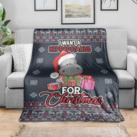 Christmas blanket on sofa with hippopotamus in green outfit, red scarf, and presents design