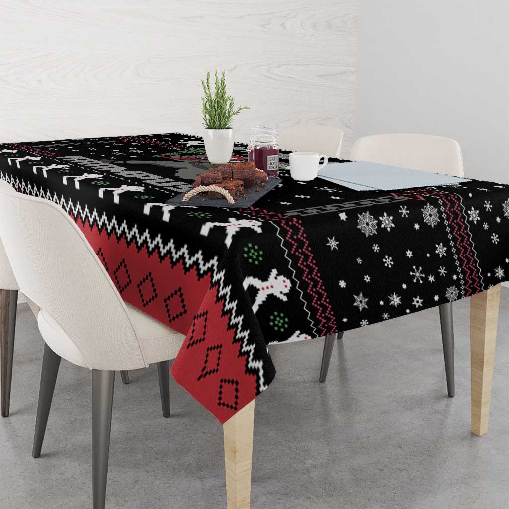 Black holiday tablecloth with red, white, and green Krampus icons and snowflake motifs