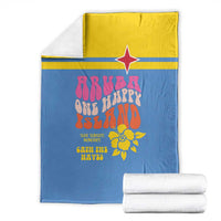 Folded blue beach graphic blanket with yellow top edge, red star, and coral-themed print