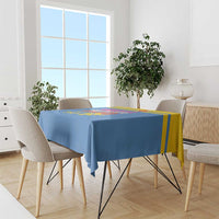 Blue tablecloth with yellow stripes and colorful festival print on dining table