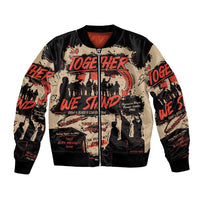 Black bomber jacket with ribbed trim, zipper front, and Together We Stand graphic; red lining.