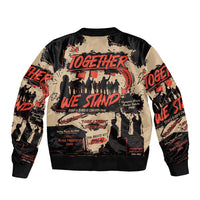Black bomber jacket with ribbed trim and Together We Stand graphic, long sleeves.