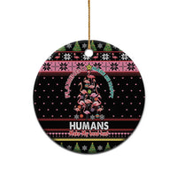 Black round ceramic ornament with Flamingo Humans graphic and gold hanging loop