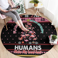 Round black flamingo Christmas carpet showing “HUMANS Make My head hurt” design