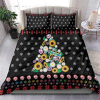 Black duvet cover and pillowcases with peace symbol, floral Christmas tree graphic.