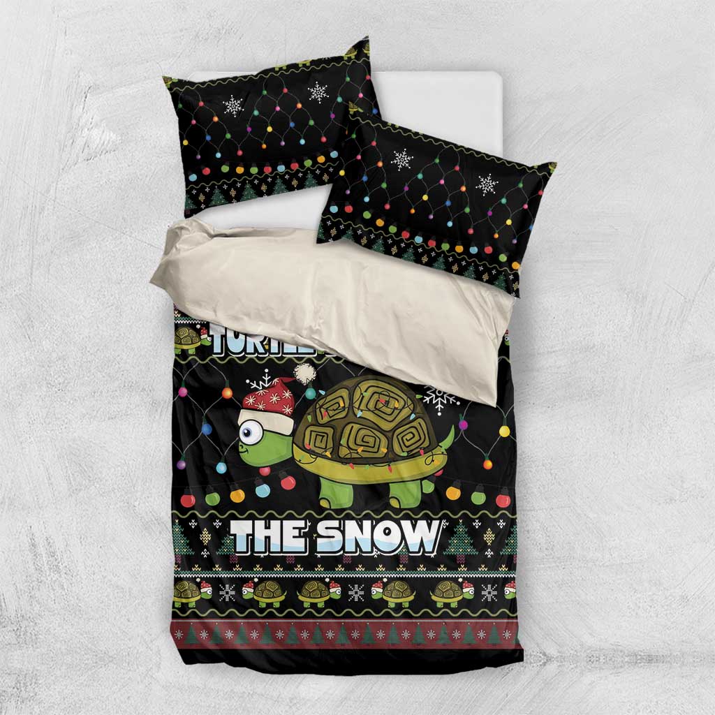 Black bedding set shown folded: duvet with turtle “THE SNOW” print and two pillowcases
