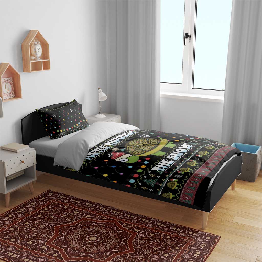 Black Christmas duvet and pillow set on a bed with turtle “THE SNOW” graphic