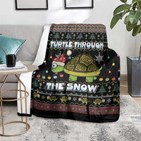 Black holiday throw blanket with turtle graphic and snow typography on rug