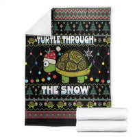 Black holiday throw blanket with turtle and snowflake print, folded stack