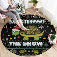 Black round turtle-themed Christmas rug with colorful lights and “THE SNOW” lettering
