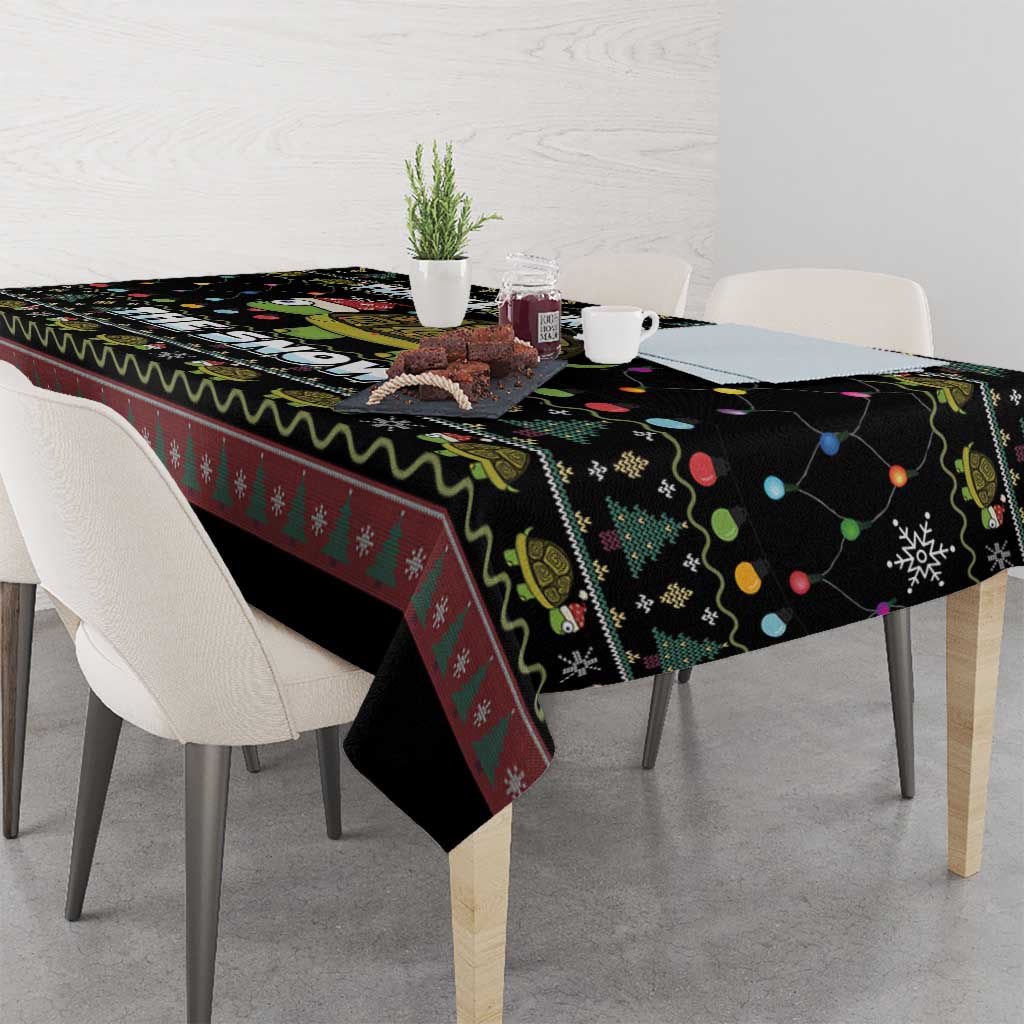Black tablecloth with turtle-and-snow design, colored string lights and zigzag trim