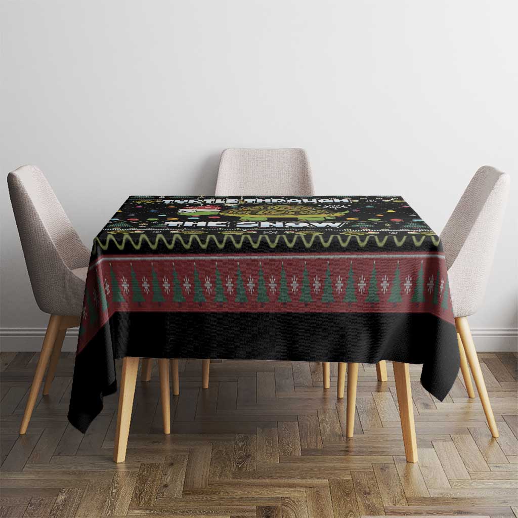 Black tablecloth with red-and-green pine tree stripe and colorful turtle snow graphic