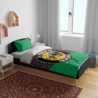 Duvet cover set on bed with green pillows and black leopard print, panther emblem