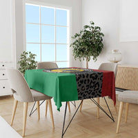 Panther tablecloth with green drape, black leopard-style print, and red side panels