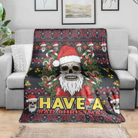 Christmas blanket draped on a sofa, showing skull Santa, trees, and 'HAVE A RAD CHRISTMAS' text