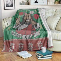 Green blanket with cartoon Jesus portrait, balloons, and red holiday snowflake trim