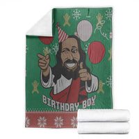 Green Jesus blanket with cartoon portrait and balloons, folded with red snowflake trim