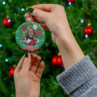 Green circular Jesus birthday ceramic ornament held with gold hanging loop and red details