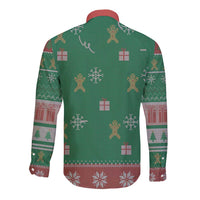 Green long-sleeve button-up shirt with back holiday pattern of gifts and reindeer