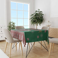 Green and red patterned tablecloth with snowflake motifs and stripes