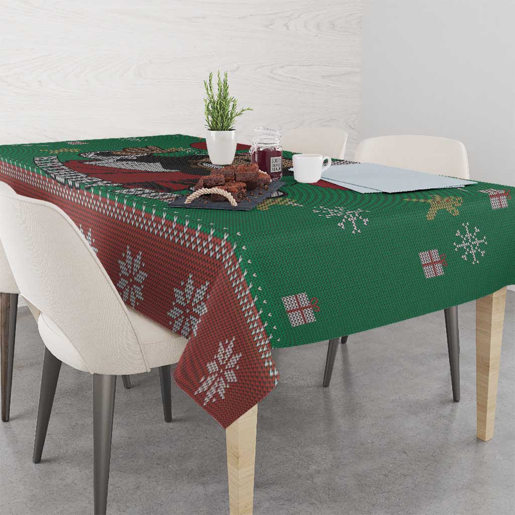 Green and red tablecloth with repeating geometric snowflake design, draped on table