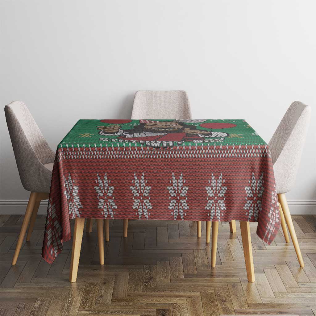 Green and red tablecloth with patterned row and small Jesus illustration