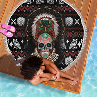 Round black beach blanket showing Native skull headdress print, white tassel-fringe border