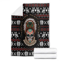 Black skull warrior blanket with headdress portrait, folded with two white blankets beside