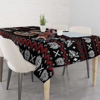 Black tablecloth with red, white, and multicolor skull pattern along the tabletop