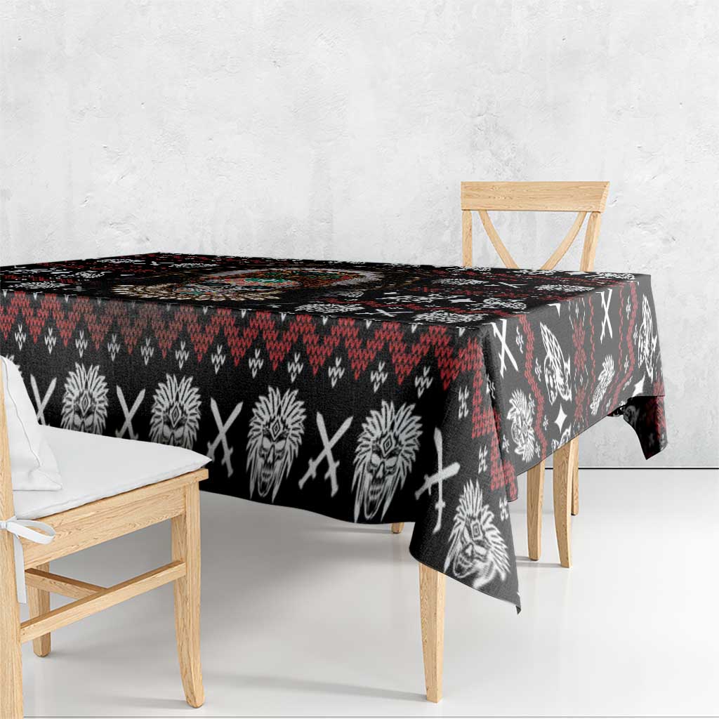Black tablecloth with red and white tribal skull and feather motifs, draped edge
