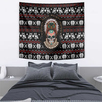 Black tribal skull tapestry with central headdress face, hanging above bed