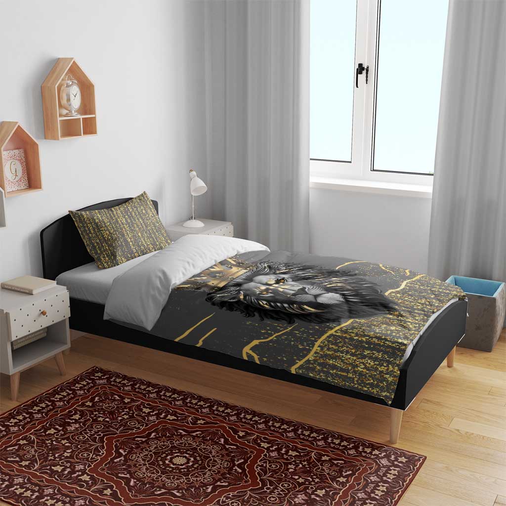Crowned lion dark gray bedding set on bed with gold speckle print and matching pillows