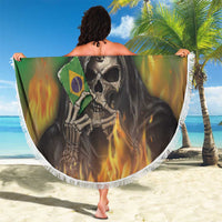 Round green beach blanket with reaper skull graphic and white fringe, held open