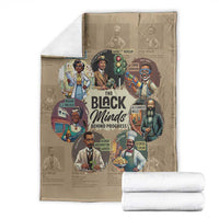 Beige blanket with portrait collage design, folded with white rolled blankets