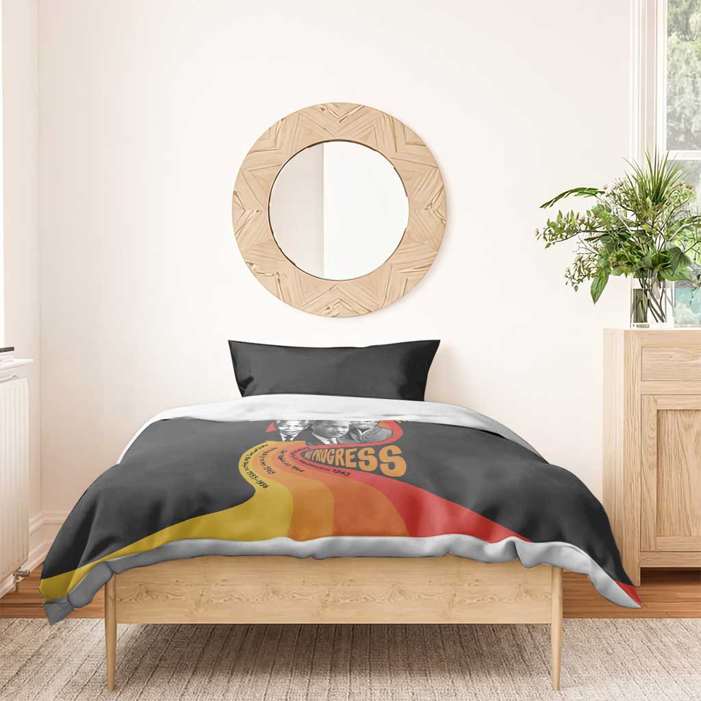 Black bedding set on wooden bed with civil rights leaders artwork on duvet cover