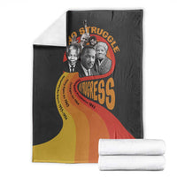 Black blanket with leaders collage, “No Struggle” text, and folded white fabric roll set