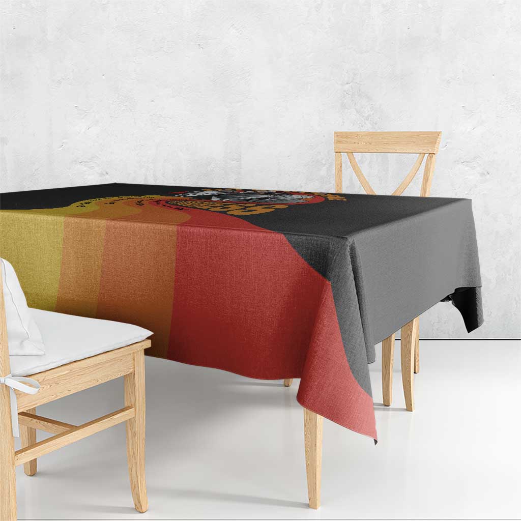 Black tablecloth with multicolor stripe panels draped over dining table corner