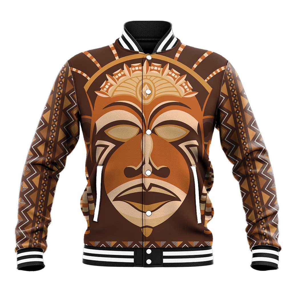 Brown baseball jacket with full-face mudcloth-style mask graphic, snap button front