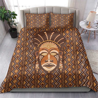 Brown African printed bedding set with tribal face center and diamond stripe border on duvet.