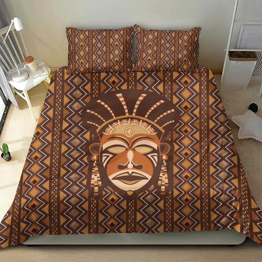 Brown printed duvet and pillow set with tribal face artwork and geometric stripe trim.