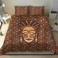 Brown printed duvet and pillow set with tribal face artwork and geometric stripe trim.