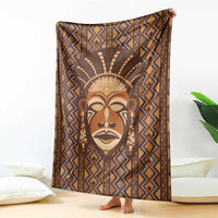 Brown tribal face printed blanket with zigzag diamonds and decorative border.